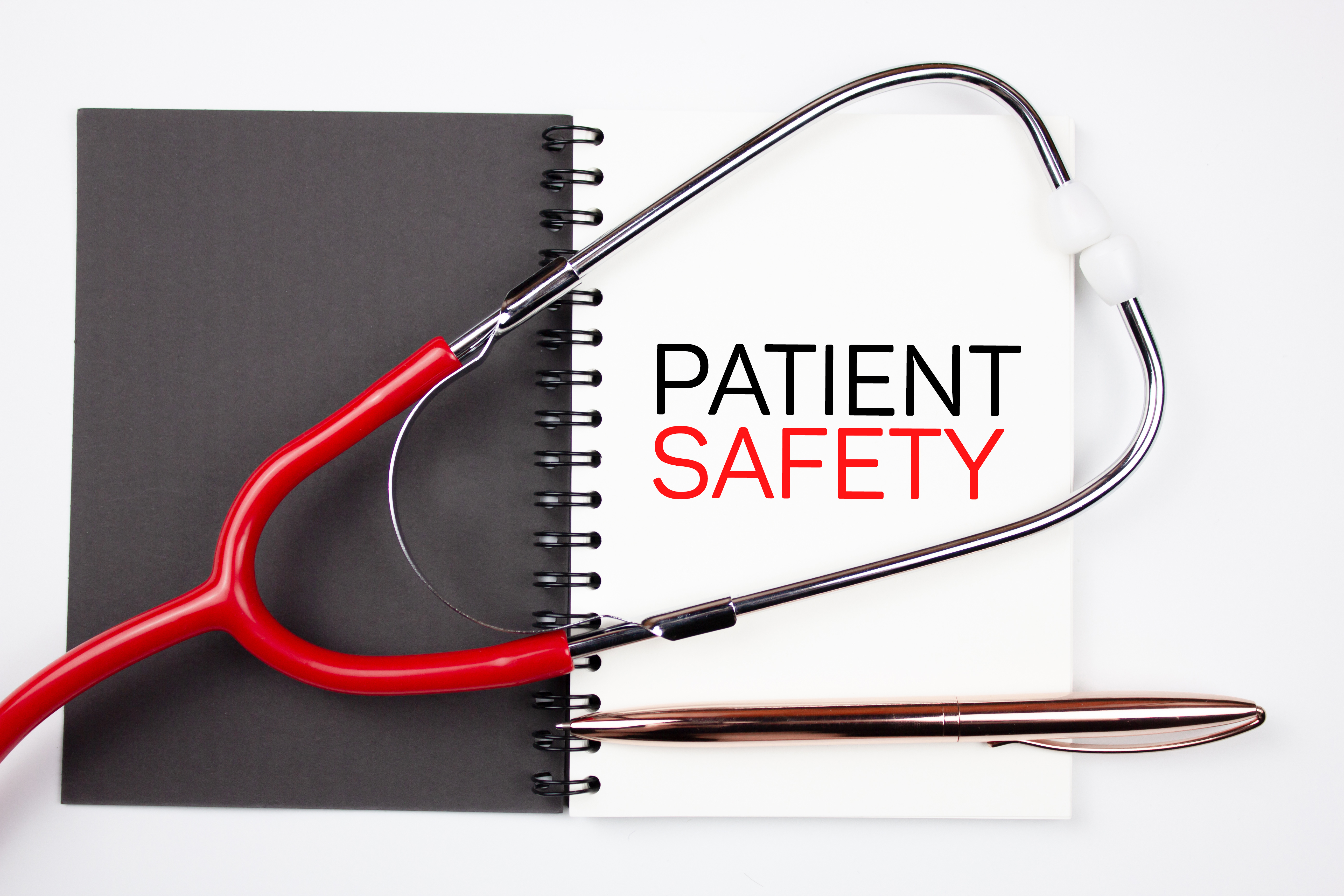 Patient Safety - text concept on notepad with medical stethoscope. Medical concept PATIENT SAFETY.